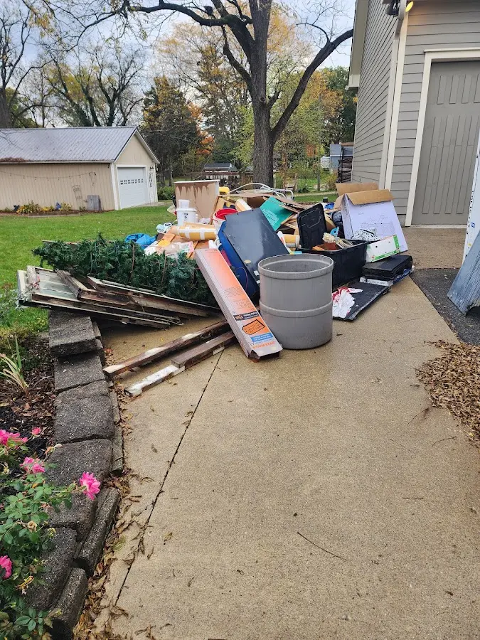 Dumpster being loaded with debris for 12 Yard Dumpster Rental in Fairview
